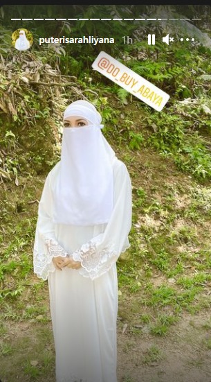 May be an image of headscarf, outdoors and text that says "puterisarahliyana 1h @D0 BUY ABAYA"